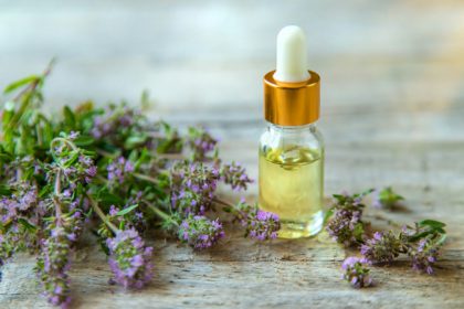 Essential oil of thyme in a bottle. Selective focus.