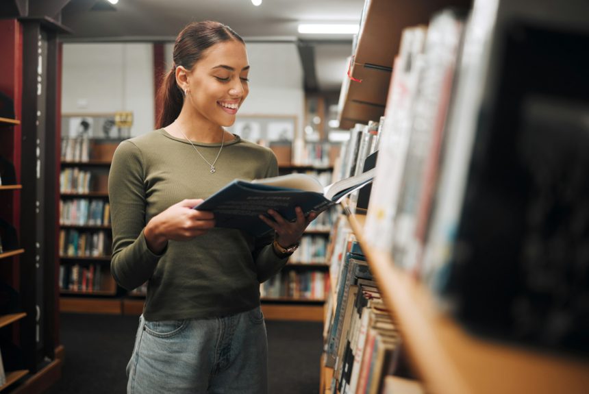 Reading, library book and woman student with a smile about learning, books and college study. Unive