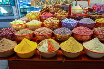 Traditional spices market. Pots and wooden tubs stand in row with colorful tea, spices, fruits, root